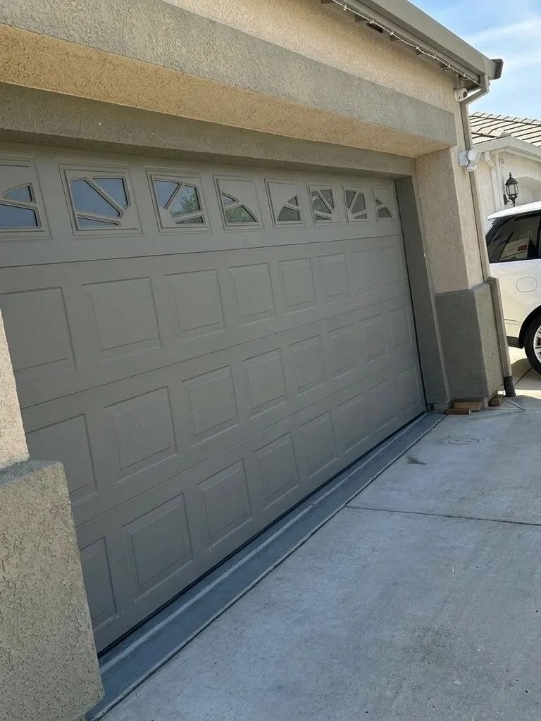 The same door back on its track, re-aligned and re-tensioned.